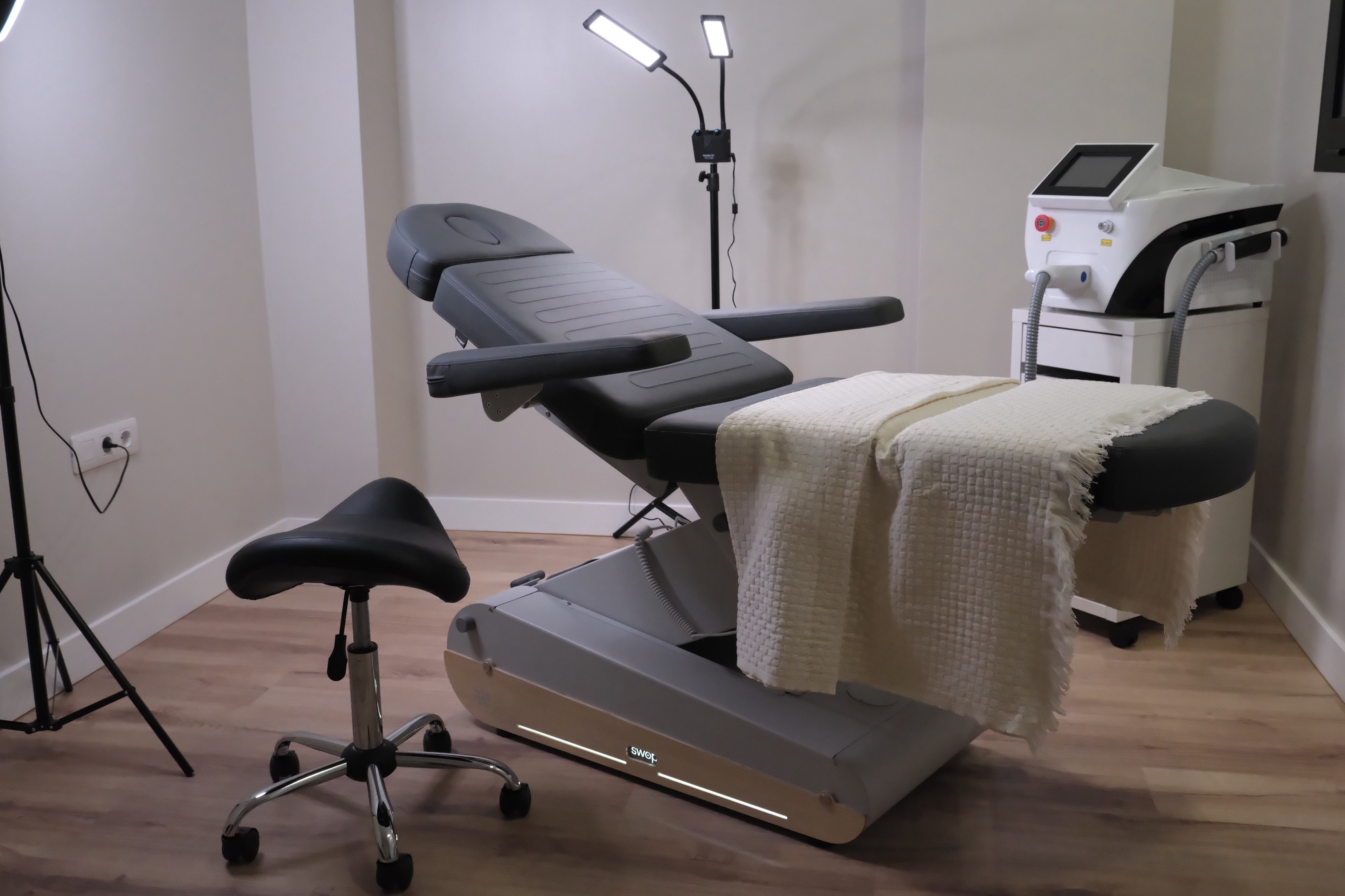 Treatment room with bed and laser hair removal equipment